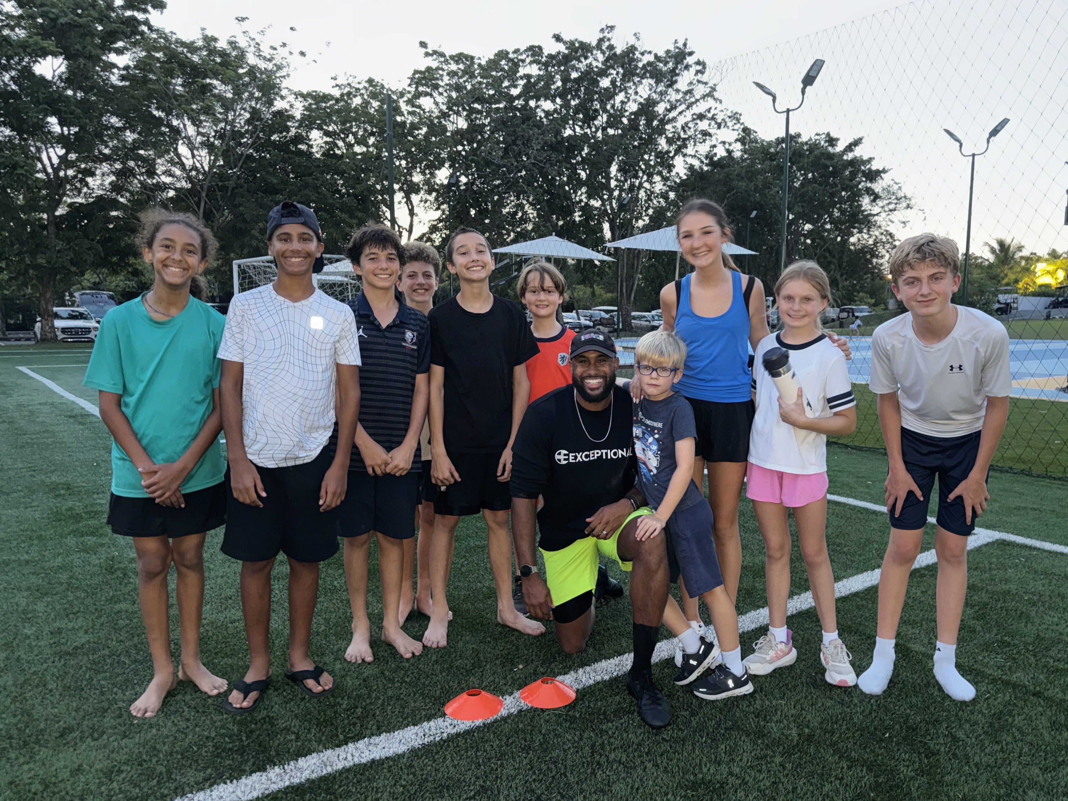 NEXT Performance Program athletes with coach at dusk